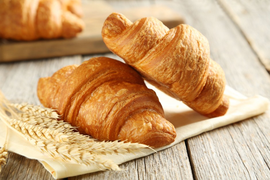 43598759 - tasty croissants with spikelets on grey wooden background