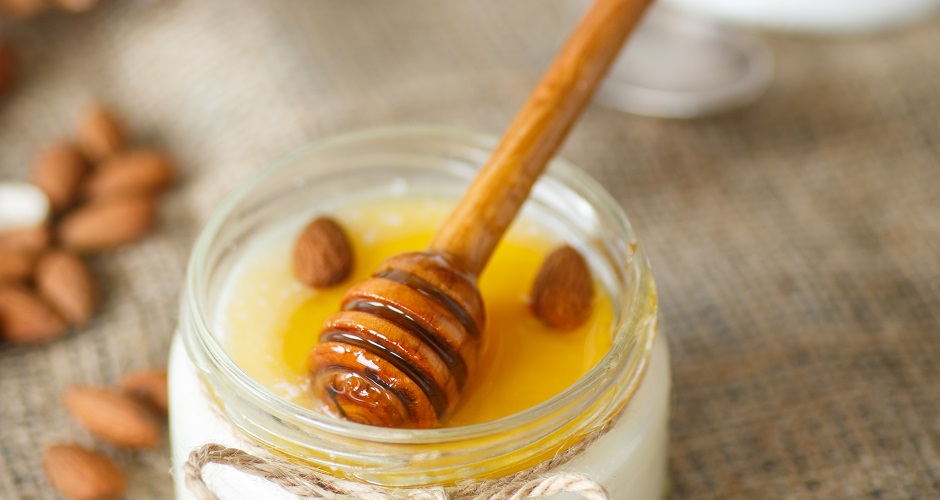 homemade yogurt with honey and nuts in a glass jar