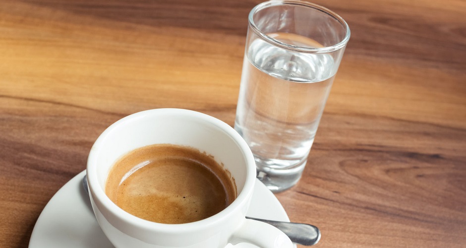 55576789 - a cup of espresso coffee and small glass of fresh water
