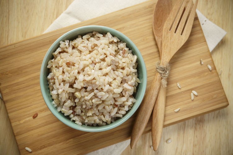 42742717 - brown rice on wooden plate