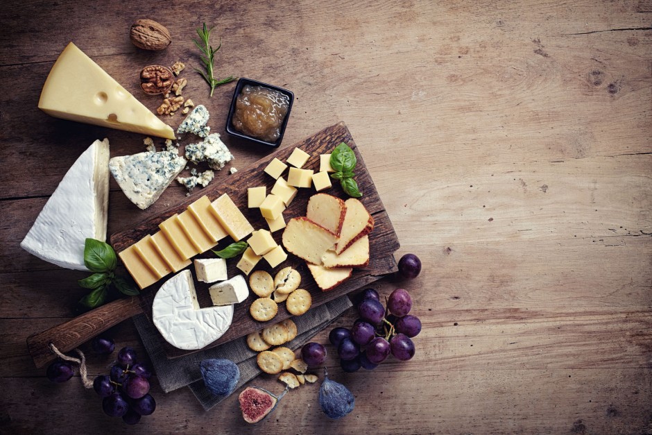 44807393 - cheese plate served with grapes, jam, figs, crackers and nuts on a wooden background