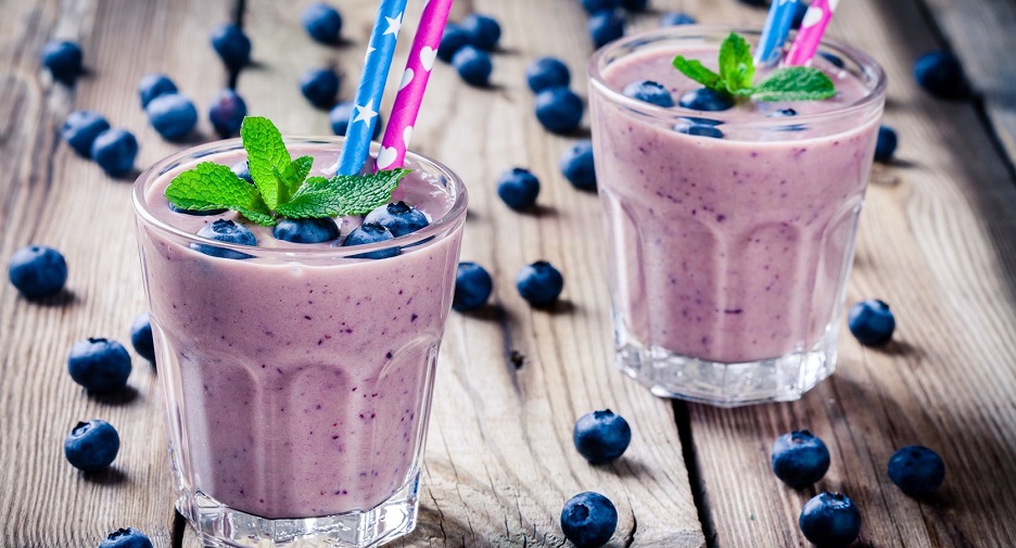 55154344 - blueberry smoothie in a glass on a rustic table